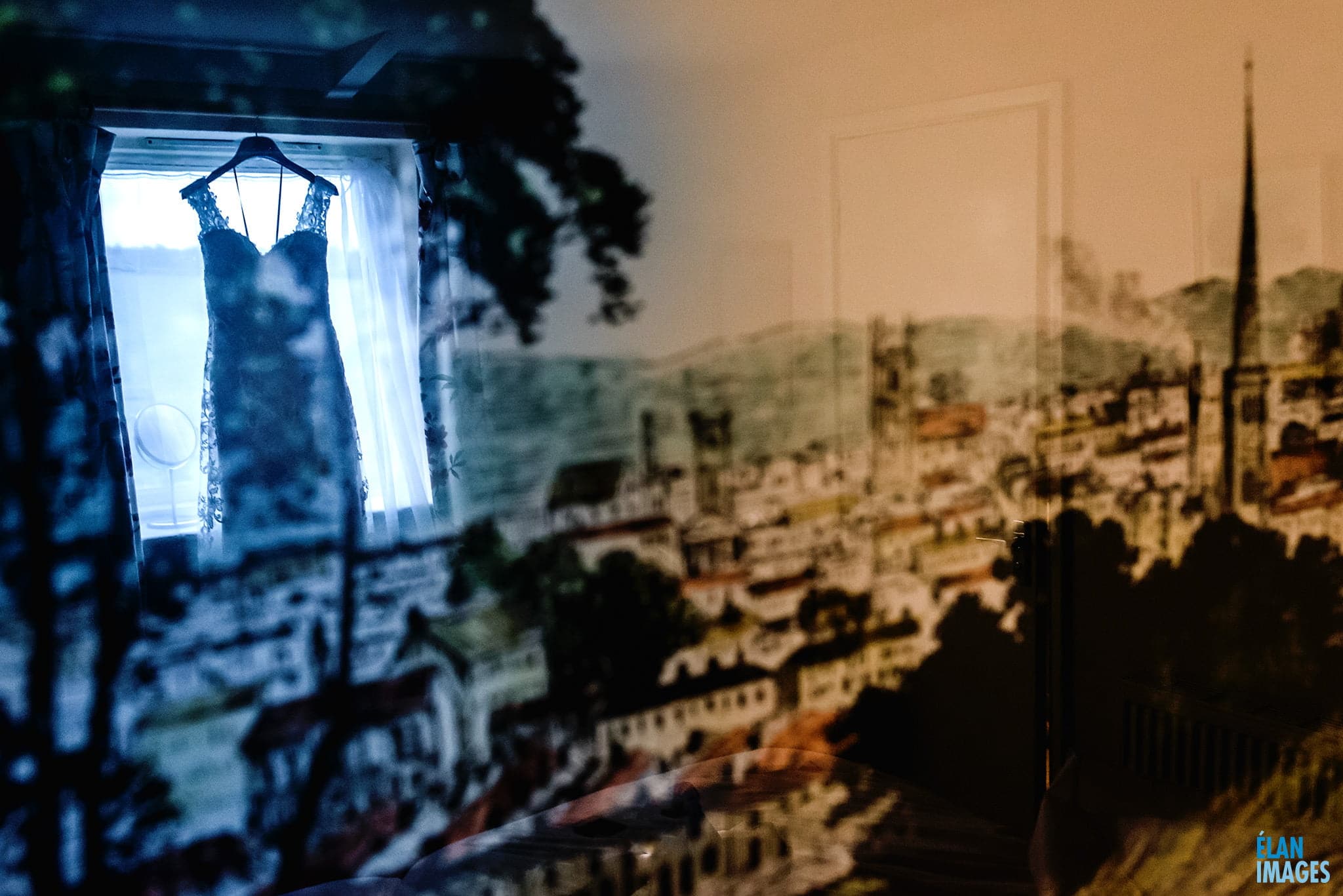 Wedding dress hanging in the window at the Great Tythe Barn Tetbury