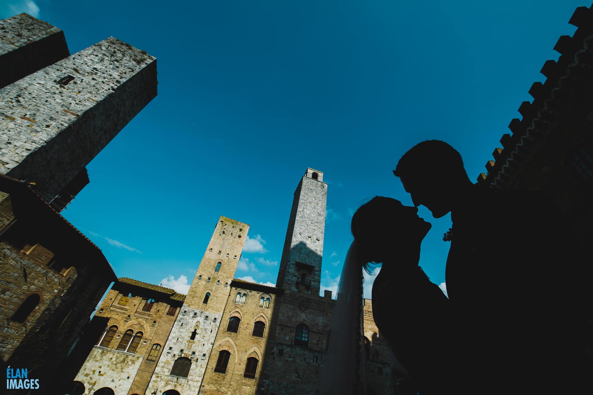 Bride and groom photographed in the midday sun just after their wedding at San Gimignano in Italy