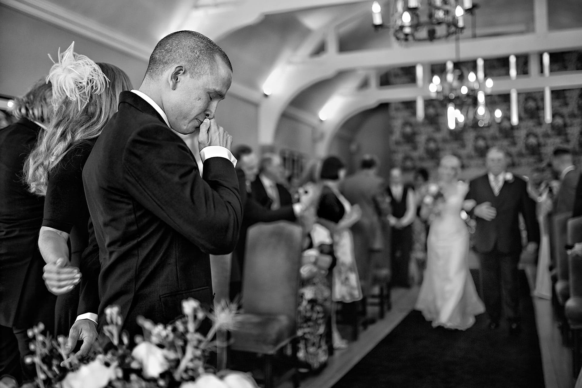 Fearless Photographers Award Winning Wedding Photograph - Matt the groom shortly before getting married as his fiancee walks up the aisle towards him, at the Hare & Hounds Hotel in Westonbirt