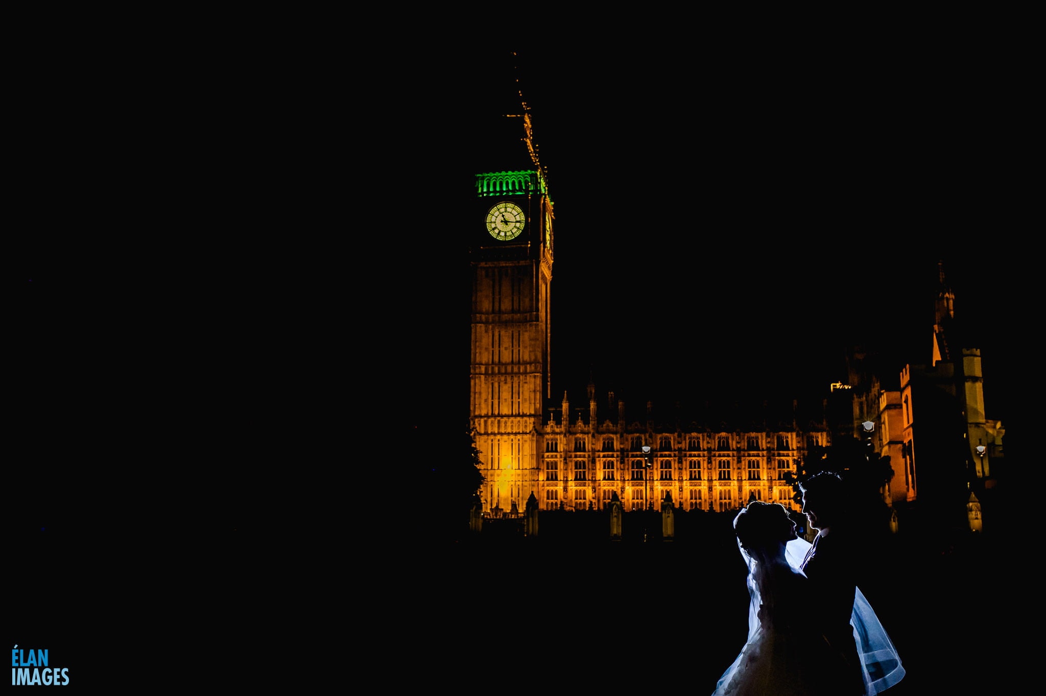 Westminster Wedding Photographer- Wedding at One Great George Street, bride and groom photographed standing outside the Houses of Parliament at Night