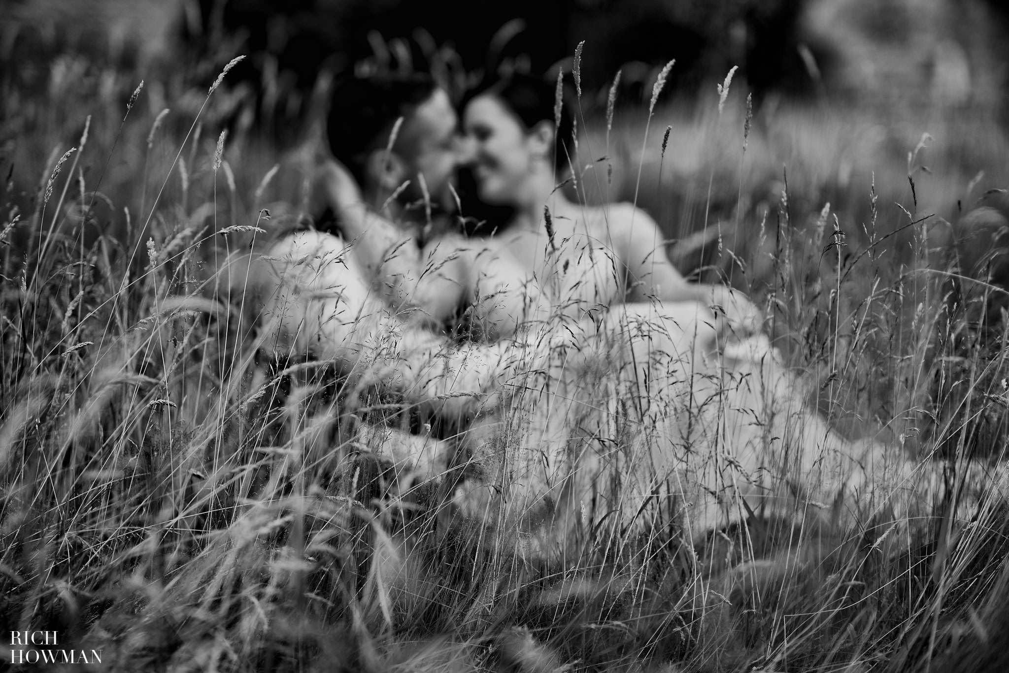 Black and white wedding photography at Iscoyd Park wedding of the bride and groom in the long grass