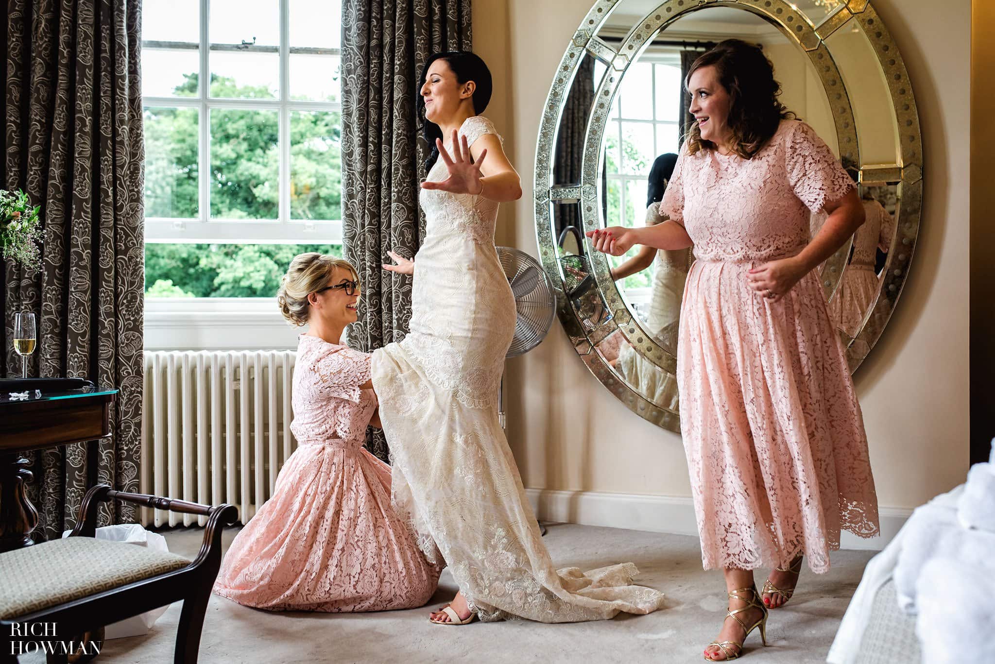 Iscoyd PArk Wedding - Bridesmaids having fun helping the bride get ready for her wedding at Iscoyd Park wedding photographed by Rich Howman Photography