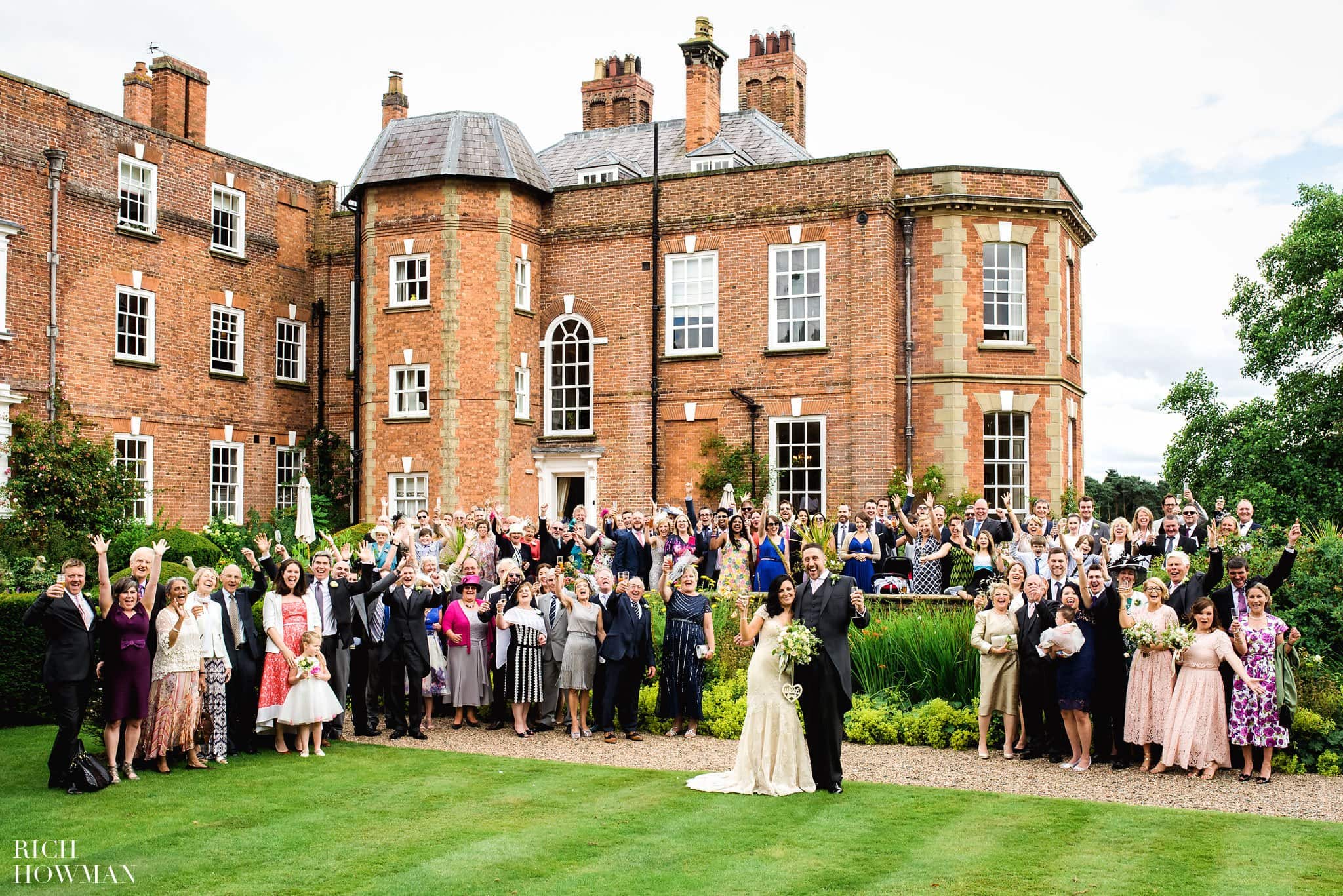 Group photo of everyone outside the back of the main house during this Iscoyd Park wedding