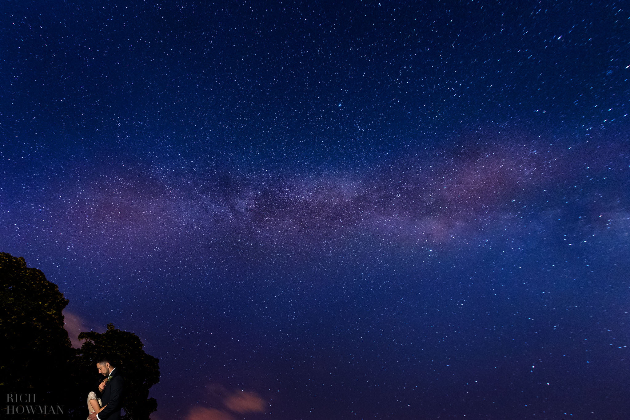 Wedding photo of the bride and groom under the milky way and stars at their Iscoyd Park wedding in Wrexham, Wales