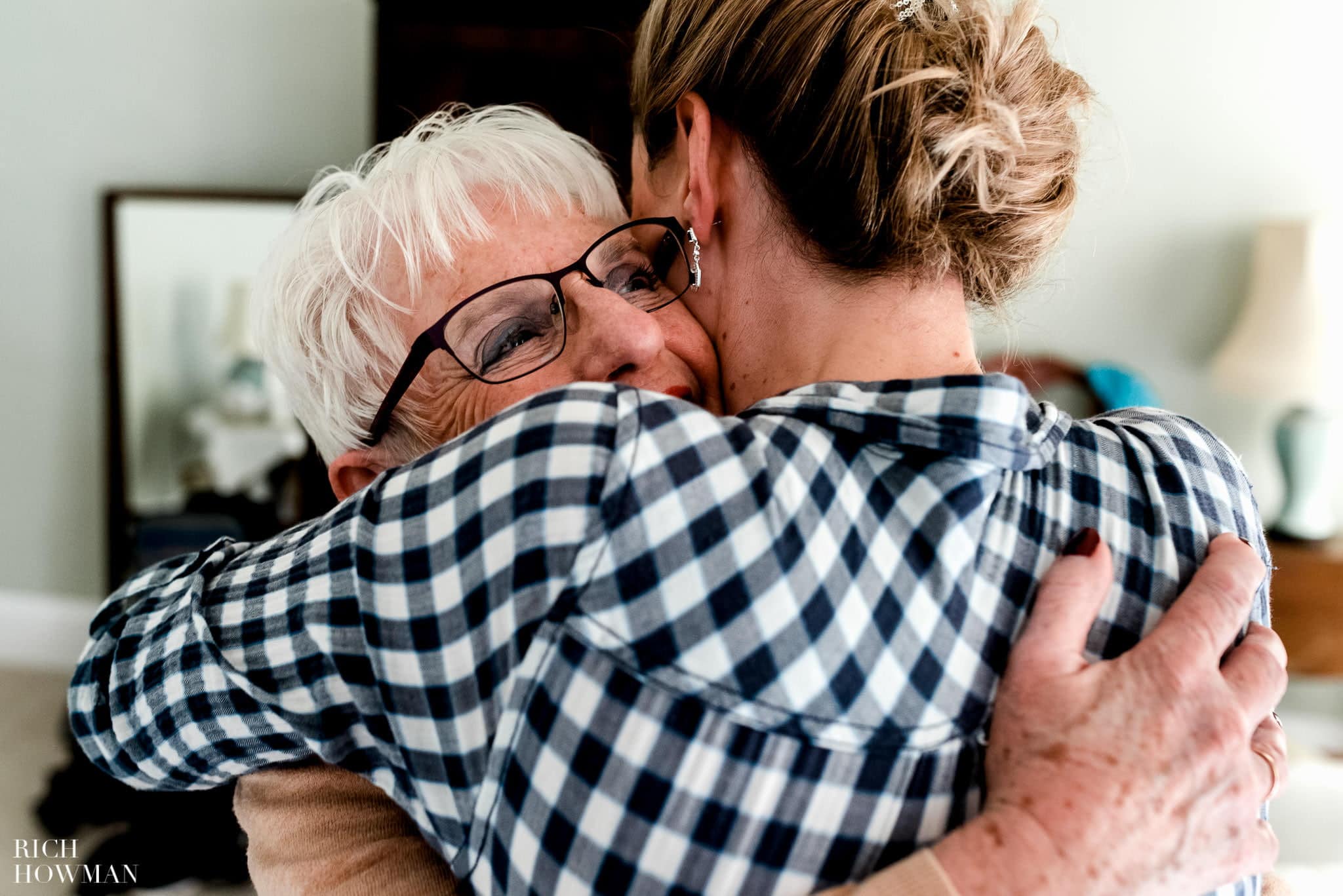 Wedding Photography at Pennard House in Somerset. The brides mum hugs her on the morning of her wedding at Pennard House