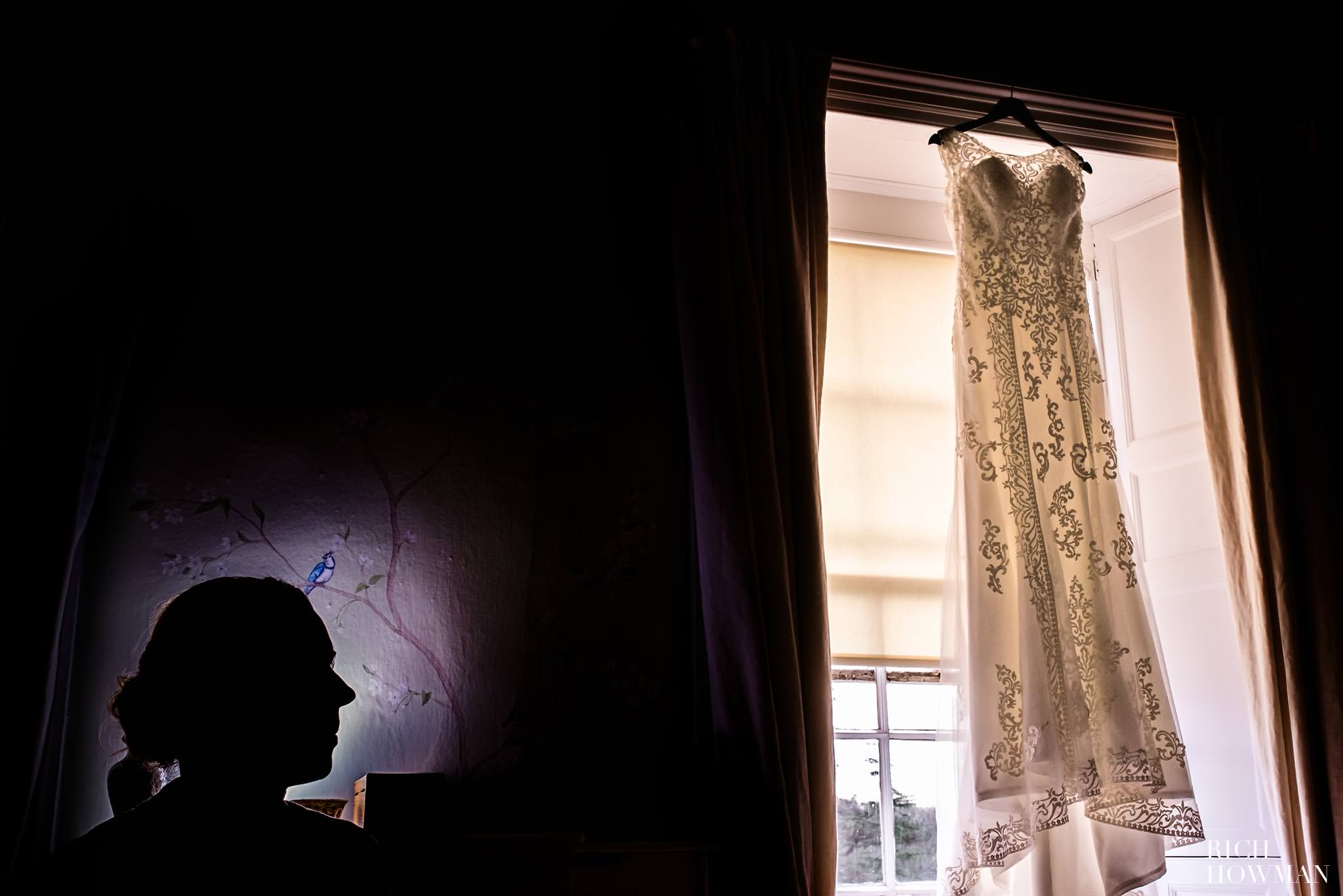 Relaxed wedding photographer at Pennard House, the bride looking at her wedding dress