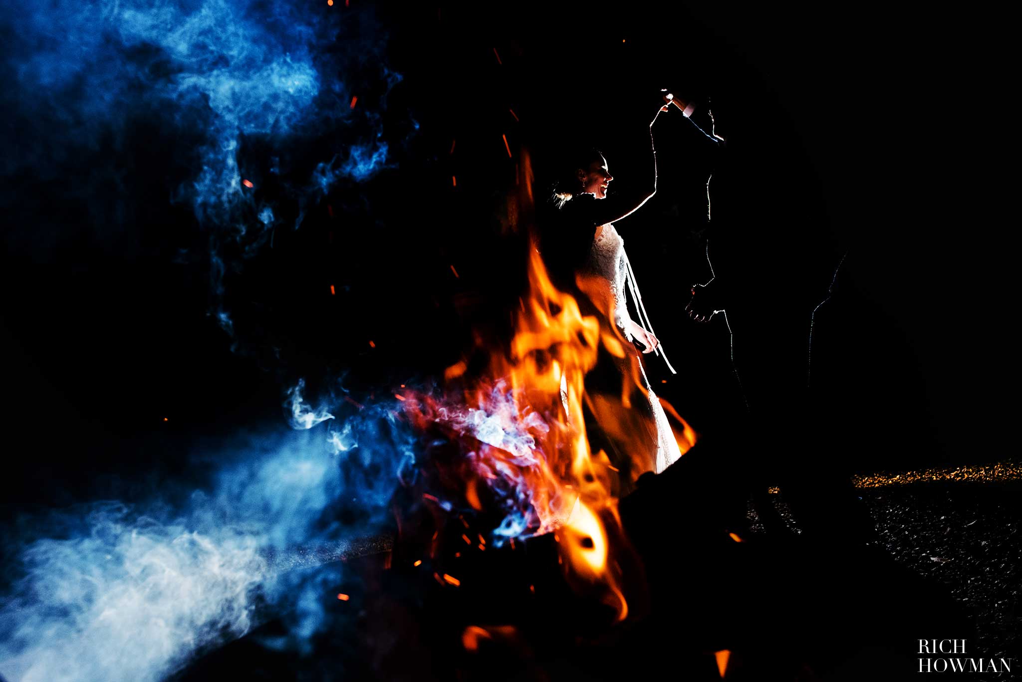 Pennard House Wedding - the bride and groom photographed by the fire pit at their Pennard House Wedding