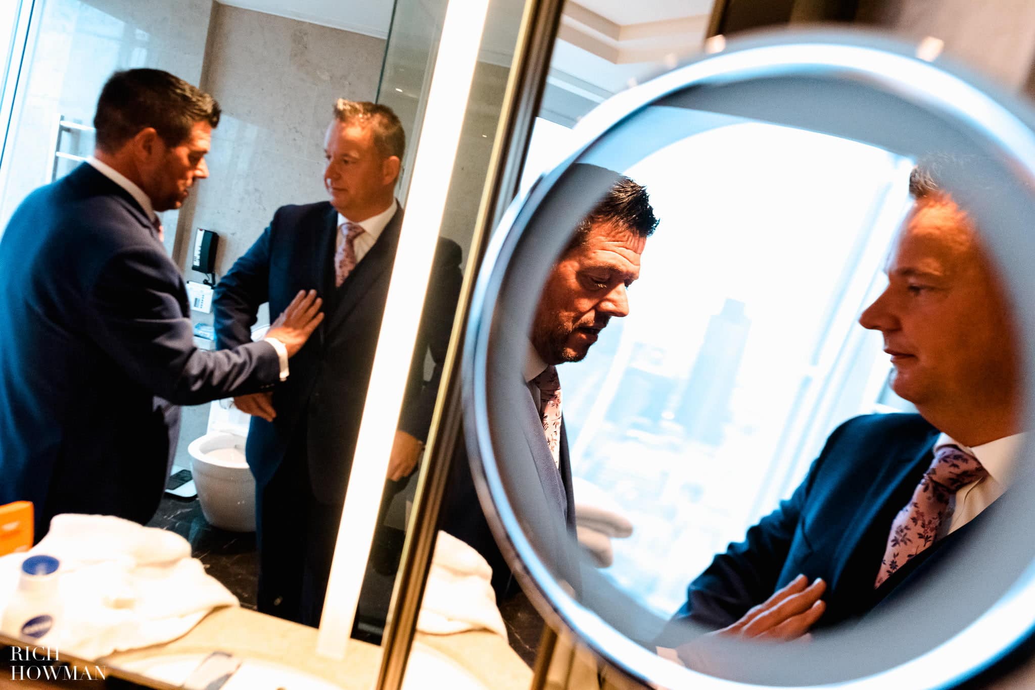 Reflections of the grooms getting ready at the Shangra-la hotel at the Shard in London before their wedding
