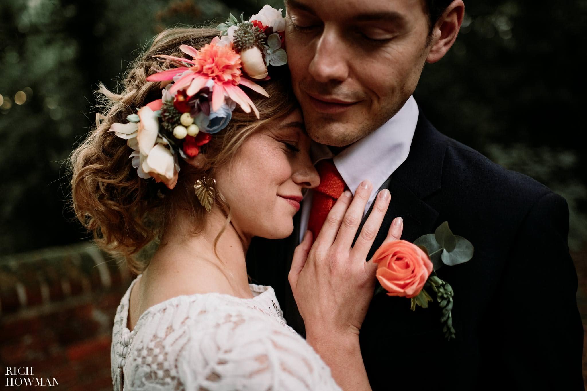 Boho Wedding Photographer for a wedding in the woods. Bride and Groom snuggle up for wedding photos